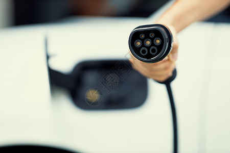 渐进式的焦点手指向摄像头充电插头的想法 背景模糊汽车车站居民电池相机收费技术发动机活力绿色图片