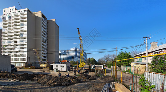 建筑工地轮光灯工人起重机安全帽工程师职业日落图片