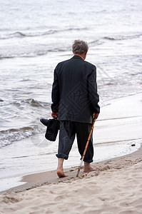 在海滩上行走孤独男士思维活动沉思海浪甘蔗休闲游客场景图片