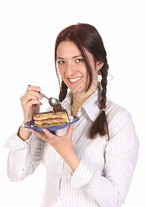 美丽的女人吃着蛋糕一块勺子生日诱惑工作室糕点喜悦食物盘子营养奶油图片