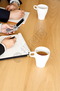 商界人士工作员工办公室饮料记事本推介会助手团队杯子会议图片