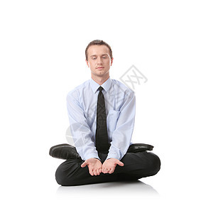 坐在莲花位置的商务人士工作瑜伽工作室身体白色成人套装人士眼睛男性图片
