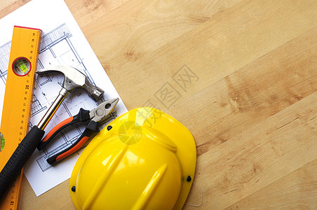 就业难素材建筑建造锤子黑色工具改造工作就业安全帽导师蓝图木头背景