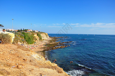 葡萄牙海滩旅行假期生活村庄太阳场景海浪支撑阳伞天空图片