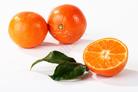 半个橘子绿色食物热带水果橙子叶子美食树叶图片