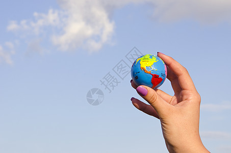 手握着地球行星手指天空世界地理女性指甲全球蓝色手臂图片