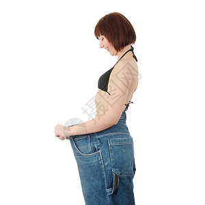 年轻女人展示自己瘦了多少体重身体姿势蓝色美丽屁股女士牛仔裤女性饮食工作室图片