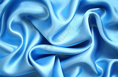 平滑优雅的蓝色丝绸作为背景织物曲线礼物艺术布料投标银色奢华纺织品折痕图片