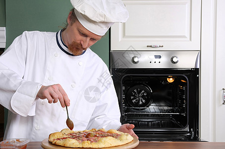 年轻厨师在厨房做意大利披萨食物美食午餐服务男性工作衣服男人烹饪工人图片