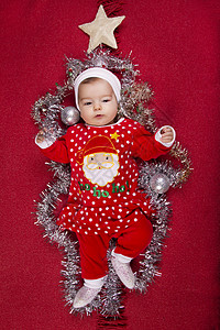 圣诞新生儿婴儿孩子新生季节女孩红色星星假期姿势说谎快乐图片