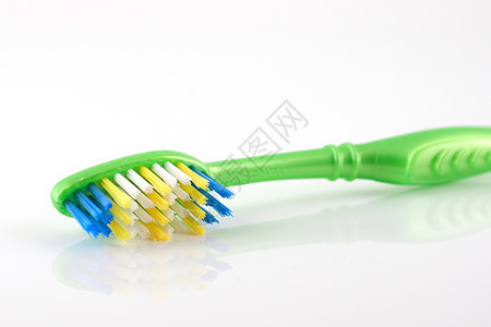 绿色手柄的牙刷牙膏刷子美丽假牙反射牙医卫生员卫生塑料宏观图片