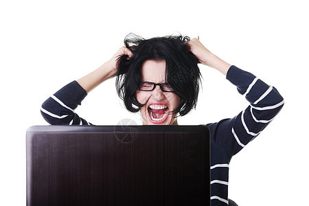 在笔记本电脑上工作的受挫妇女坚果女孩技术牙齿商务碰撞愤怒女士尖叫青少年图片