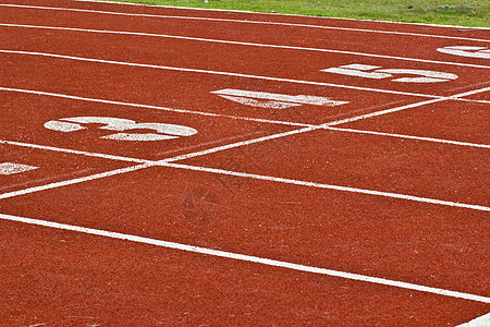 带有数字的赛车道蓝色地面场地课程竞赛运动体育场赛跑者赛马场短跑图片