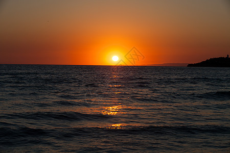 日落在海面上火鸡波浪天空海洋金子气候环境孤独地平线天堂图片
