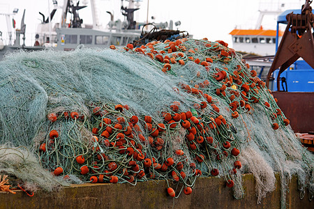 渔网套式渔网钓鱼海洋红色材料齿轮港口宏观漂浮物纠纷绳索图片