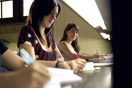 快乐的女学生在大学图书馆里笑着微笑图片