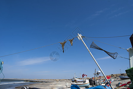 渔船海洋天空钓鱼木船着陆沙丘假期地平线蓝色渔业图片