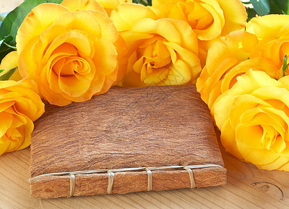 书上的黄玫瑰说谎宏观艺术桌子手工稻草树叶边界木头花瓣图片