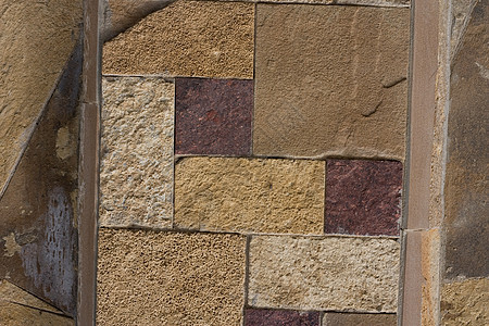 由岩石制成的墙壁结构褐色石头建筑石墙材料棕色历史石工图片