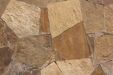 由岩石制成的墙壁结构褐色石墙历史棕色石工建筑石头材料图片