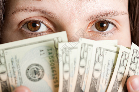 手头美元货币账单投资债务商业女性现金眼睛商务帮助财富图片