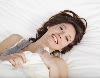 醒来后幸福快乐女孩房间枕头休息微笑成人女性福利说谎睡衣图片