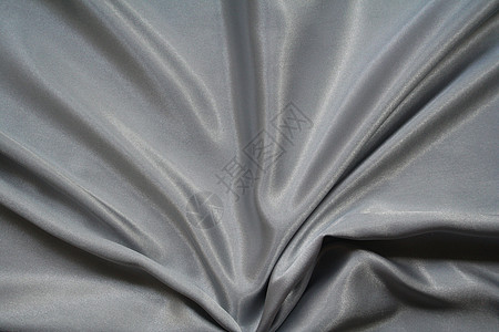 平滑优雅的银色灰色丝绸作为背景织物海浪折痕纺织品曲线黑色材料衣服版税寝具图片