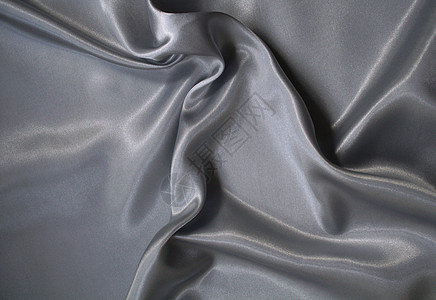 平滑优雅的银色灰色丝绸作为背景衣服投标折痕金属海浪寝具布料生产涟漪纺织品图片