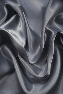 平滑优雅的灰色丝绸作为背景生产纺织品织物涟漪寝具银色海浪版税材料折痕图片