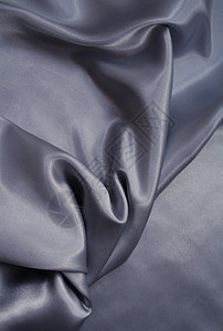 平滑优雅的灰色丝绸作为背景反光纺织品银色曲线海浪版税金属生产黑色衣服图片