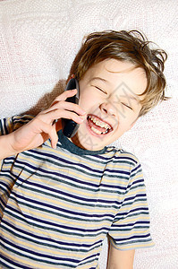 青少年男孩在手机上说话享受讲话细胞技术电话男性学生乐趣房子男生图片