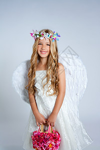 拿着带翅膀的花袋的天使女孩羽毛快乐金发女性戏服裙子卷曲头发孩子们花朵图片