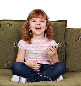 快乐的小女孩听音乐耳机女性白色喜悦女儿音乐玩家孩子房间乐趣图片