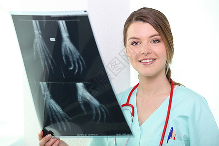 护士带着X光微笑白色x光工人蓝色诊所头发医院药品棕色女性图片