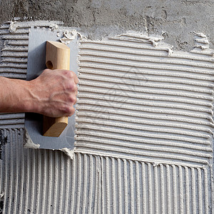 白色水泥的未加建造的粗地面瓷砖手工工具砂浆工人建筑学力量男人瓦工图片