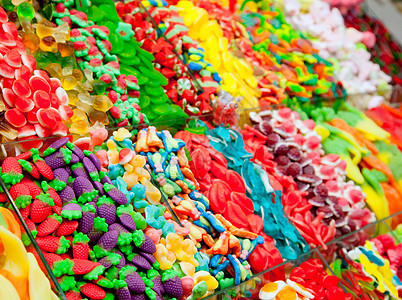彩色展示中的糖果果冻甜点孩子假期投标小吃童年市场食物店铺塑料背景图片