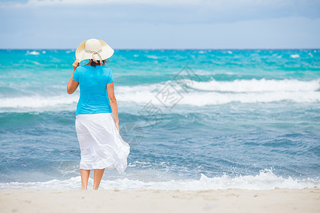 美丽的女人和海洋女士灵魂地平线沙滩帽子姿势日落身体女性海浪图片
