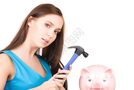 拥有小猪银行和锤子的少女黑发粉碎青少年小猪贪婪女性蓝色女孩财政银行图片