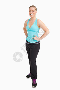 穿运动服的妇女女性运动蓝色运动鞋臀部双手浅色金发跑步快乐图片