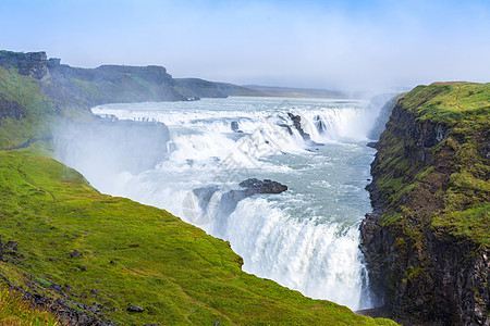 冰岛的瀑布彩虹人心水电岩石草原地标薄雾窗帘流动峡谷高清图片