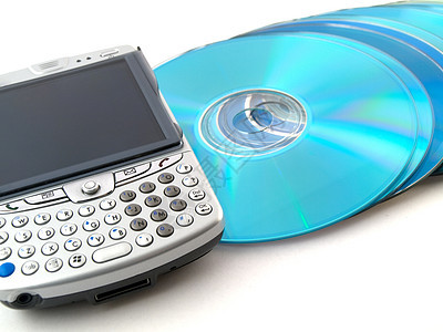 CD DVD 和关于白背景的移动电话 PDA圆圈记录圆形商业视频字节袖珍技术电脑海盗图片