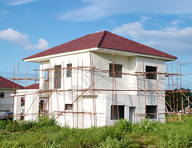 新建住宅楼木头入口天空投资抵押玻璃水泥建筑建设者树木图片