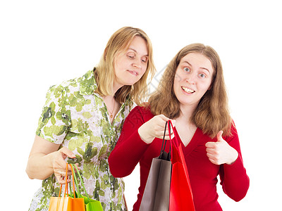 两名妇女参加购物游览贸易喜悦铺张生日拇指销售量乐趣购物狂购物袋礼物图片