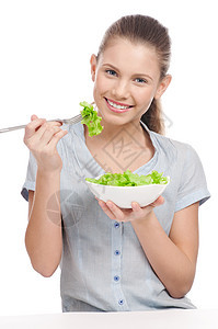 年轻美女吃生菜沙拉 孤立无援图片