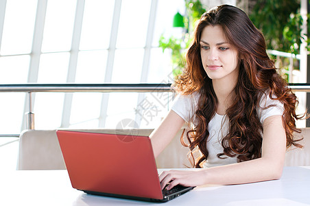 坐在咖啡馆的年轻女商务人士早餐笔记本金融桌子电脑女性人士头发商务职业图片