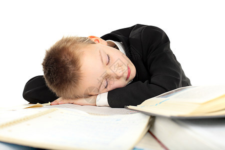疲累的在校男孩睡眠学生家庭作业小学生男性白色桌子青少年睡觉青年图片