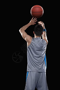 篮球运动员扔球 黑色背景图片