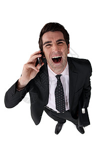 商务人士在打电话时大笑出声电话商务眼睛微笑男性管理人员工作套装人士喜悦图片