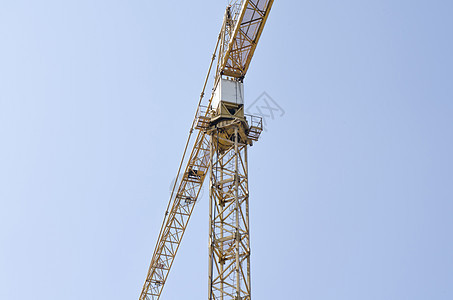 蓝色天空背景的吊起城市工作项目机器建筑金属技术摩天大楼日落起重机图片