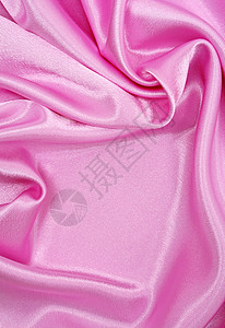 平滑优雅的粉色丝绸作为背景布料织物材料纺织品曲线婚礼投标海浪薰衣草背景图片